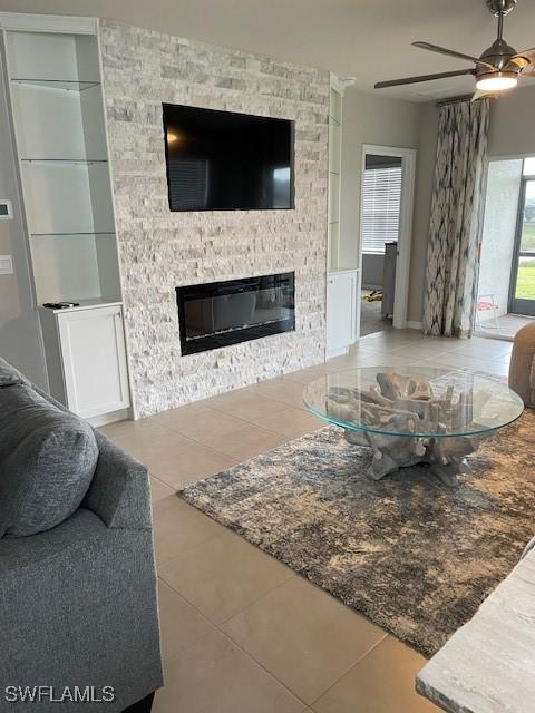 18521 Cronin Sand Ln, North Fort Myers, FL 33917 - tiled living room with a fireplace, a ceiling fan, and built in features
