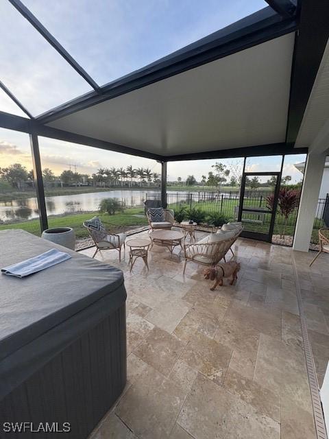 18521 Cronin Sand Ln, North Fort Myers, FL 33917 - view of patio with a hot tub, a water view, and glass enclosure
