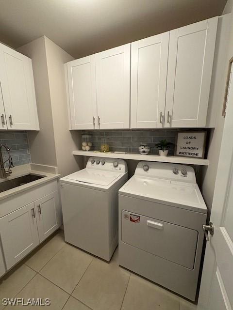 18521 Cronin Sand Ln, North Fort Myers, FL 33917 - laundry room with cabinet space, independent washer and dryer, and light tile patterned flooring