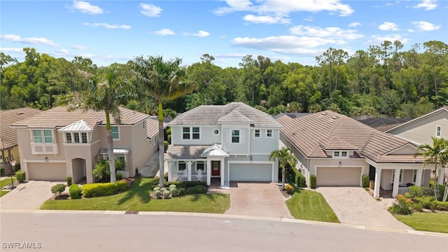 3640 Pilot Cir, Naples, FL 34120 - view of front facade with driveway, a garage, stucco siding, and a tile roof
