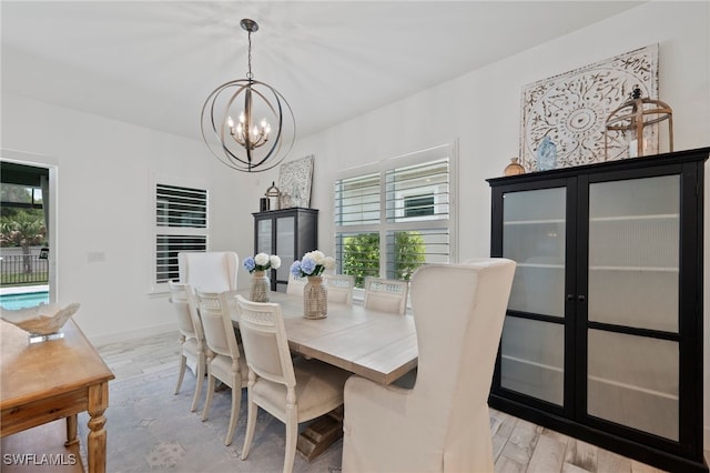 3640 Pilot Cir, Naples, FL 34120 - dining room featuring a chandelier, healthy amount of natural light, and light wood-style flooring