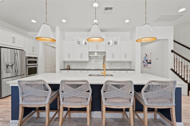 3640 Pilot Cir, Naples, FL 34120 - kitchen featuring appliances with stainless steel finishes, tasteful backsplash, glass insert cabinets, decorative light fixtures, and recessed lighting