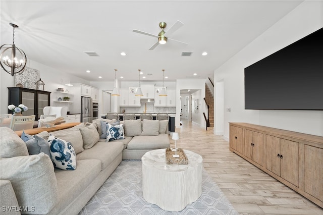 3640 Pilot Cir, Naples, FL 34120 - living room featuring light wood-style flooring, ceiling fan, a chandelier, and recessed lighting