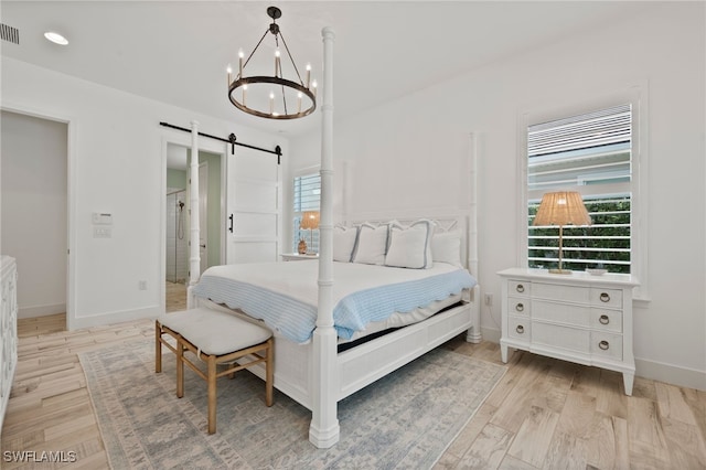 3640 Pilot Cir, Naples, FL 34120 - bedroom featuring a barn door, a chandelier, light wood-style flooring, and recessed lighting