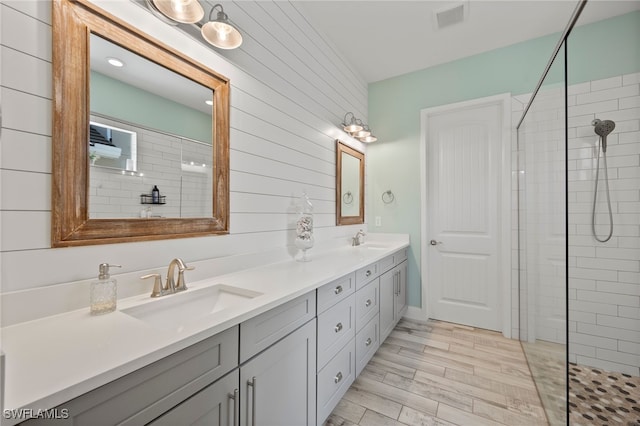 3640 Pilot Cir, Naples, FL 34120 - full bath with double vanity, tiled shower, and wood finished floors
