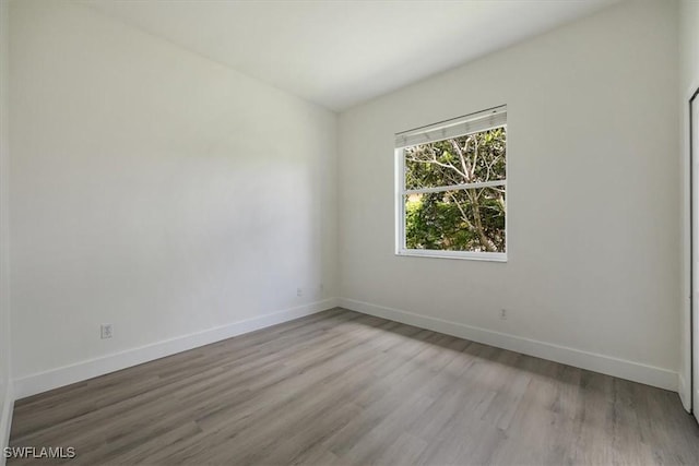 1087 Port Orange Way, Naples, FL 34120 - empty room with baseboards and wood finished floors