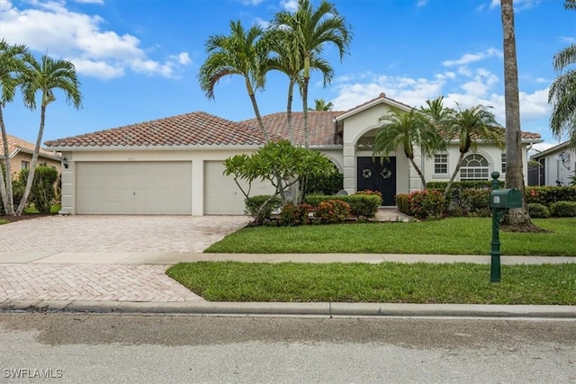 1087 Port Orange Way, Naples, FL 34120 - mediterranean / spanish-style house featuring stucco siding, decorative driveway, a front yard, and a garage