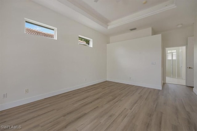 1087 Port Orange Way, Naples, FL 34120 - unfurnished room with light wood-style floors and a raised ceiling