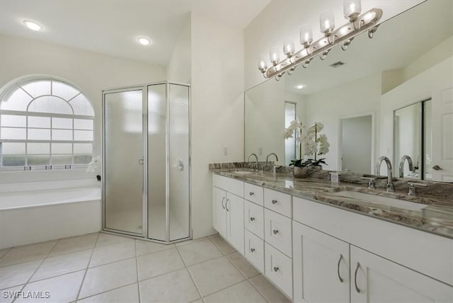 1087 Port Orange Way, Naples, FL 34120 - bathroom featuring double vanity, a garden tub, a stall shower, and tile patterned flooring