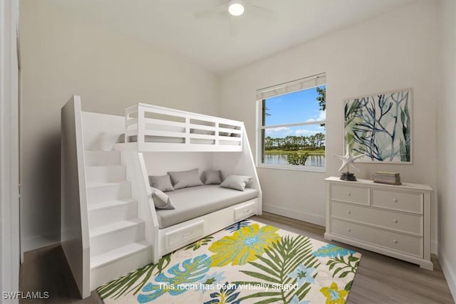 1087 Port Orange Way, Naples, FL 34120 - bedroom with wood finished floors and a ceiling fan
