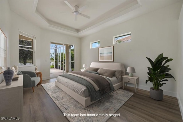 1087 Port Orange Way, Naples, FL 34120 - bedroom with access to exterior, a tray ceiling, and wood finished floors