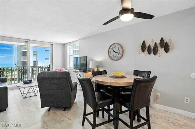 5600 Bonita Beach Rd Unit 4-605, Bonita Springs, FL 34134 - dining space with ceiling fan and light marble finish floors