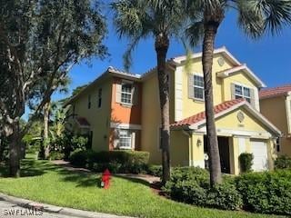 4400 Lazio Way Unit 201, Fort Myers, FL 33901 - mediterranean / spanish home featuring stucco siding, a front lawn, and a garage
