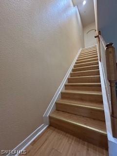 4400 Lazio Way Unit 201, Fort Myers, FL 33901 - staircase featuring baseboards and wood finished floors