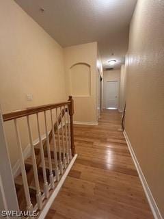 4400 Lazio Way Unit 201, Fort Myers, FL 33901 - hall with an upstairs landing and wood finished floors