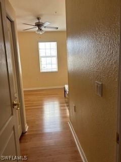 4400 Lazio Way Unit 201, Fort Myers, FL 33901 - hallway featuring wood finished floors and baseboards