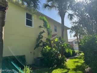 4400 Lazio Way Unit 201, Fort Myers, FL 33901 - view of home's exterior with stucco siding and a cooling unit