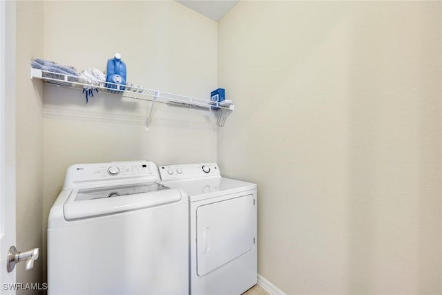 11758 Izarra Way Unit 7703, Fort Myers, FL 33912 - laundry room with washer and dryer and baseboards