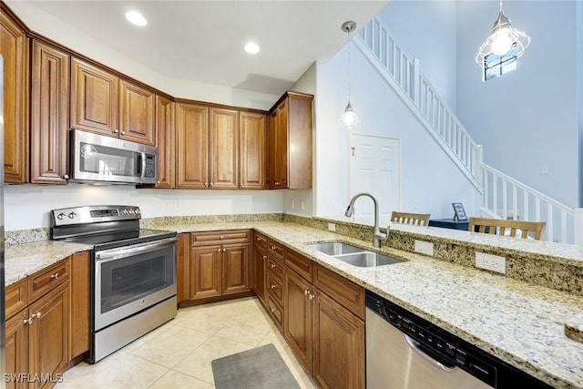 11758 Izarra Way Unit 7703, Fort Myers, FL 33912 - kitchen with stainless steel appliances, light stone counters, pendant lighting, light tile patterned flooring, and recessed lighting