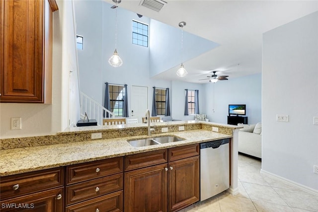 11758 Izarra Way Unit 7703, Fort Myers, FL 33912 - kitchen with dishwasher, light stone counters, a ceiling fan, and healthy amount of natural light