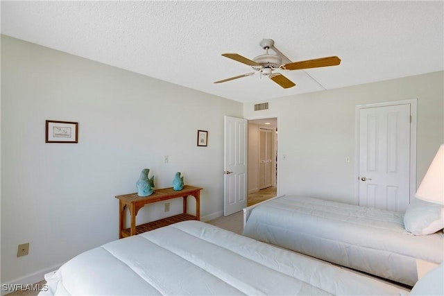 25710 Hickory Blvd Unit A 202, Bonita Springs, FL 34134 - bedroom with a ceiling fan, light colored carpet, and a textured ceiling