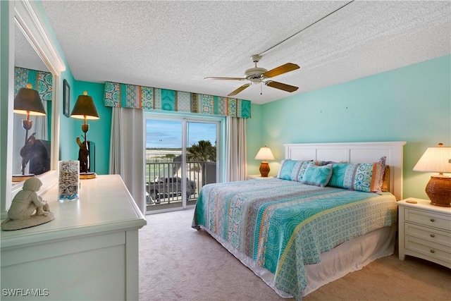 25710 Hickory Blvd Unit A 202, Bonita Springs, FL 34134 - bedroom with access to exterior, a textured ceiling, light colored carpet, and a ceiling fan