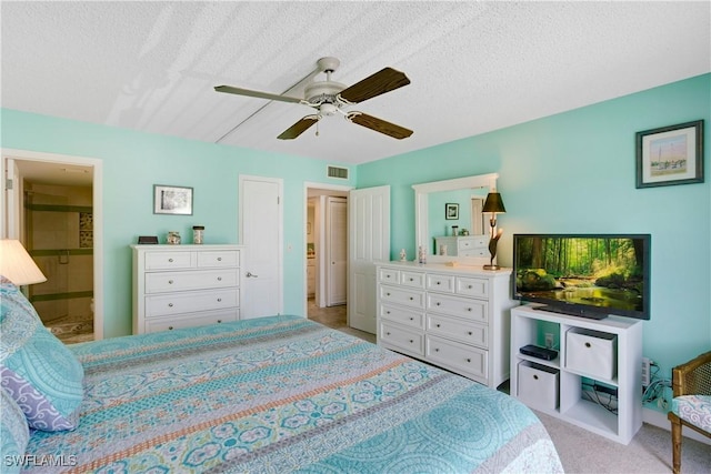25710 Hickory Blvd Unit A 202, Bonita Springs, FL 34134 - carpeted bedroom featuring a ceiling fan, a textured ceiling, and connected bathroom