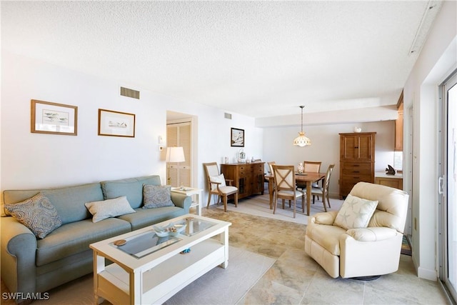 25710 Hickory Blvd Unit A 202, Bonita Springs, FL 34134 - living area featuring a textured ceiling