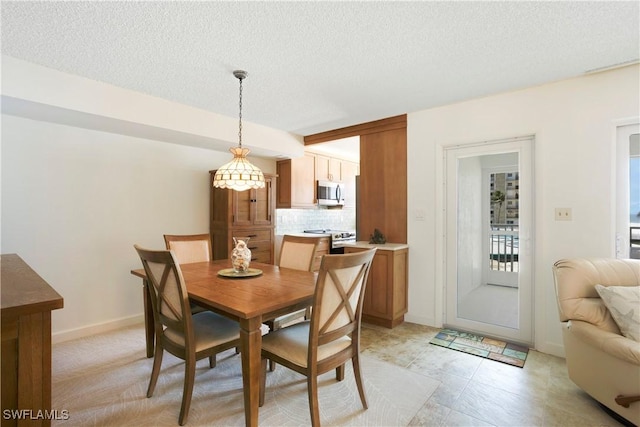 25710 Hickory Blvd Unit A 202, Bonita Springs, FL 34134 - dining room featuring a textured ceiling and baseboards