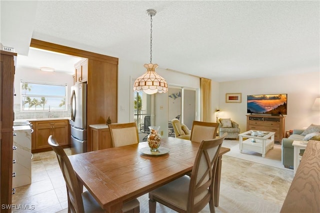 25710 Hickory Blvd Unit A 202, Bonita Springs, FL 34134 - dining area featuring a textured ceiling and light tile patterned floors