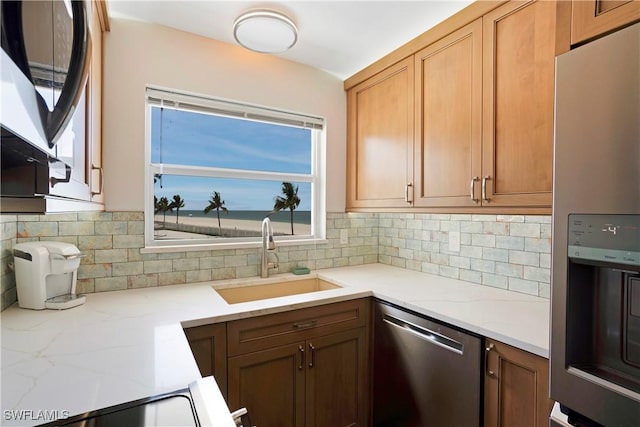 25710 Hickory Blvd Unit A 202, Bonita Springs, FL 34134 - kitchen featuring stainless steel appliances, decorative backsplash, and light stone counters