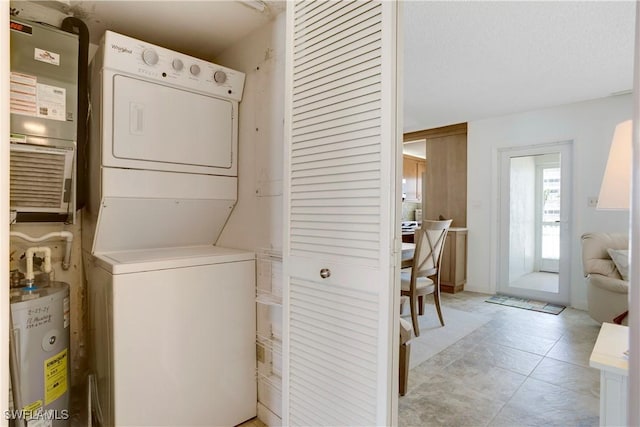 25710 Hickory Blvd Unit A 202, Bonita Springs, FL 34134 - laundry room with stacked washer and clothes dryer, electric water heater, and heating unit