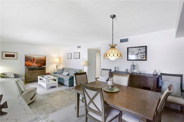 25710 Hickory Blvd Unit A 202, Bonita Springs, FL 34134 - dining room featuring a textured ceiling