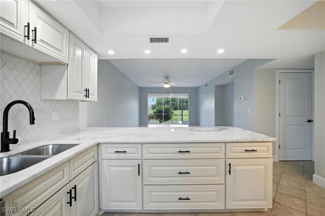 16001 Dublin Cir Unit 103, Fort Myers, FL 33908 - kitchen with backsplash, recessed lighting, a ceiling fan, a peninsula, and light tile patterned floors