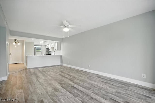 16001 Dublin Cir Unit 103, Fort Myers, FL 33908 - unfurnished living room with ceiling fan and light wood-style flooring