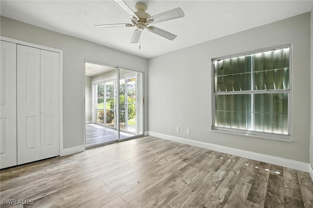 16001 Dublin Cir Unit 103, Fort Myers, FL 33908 - unfurnished bedroom with access to outside, wood finished floors, and a ceiling fan