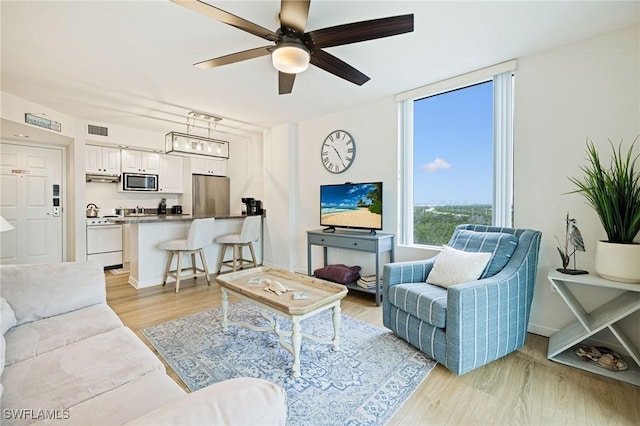 8771 Estero Blvd Unit 607, Fort Myers Beach, FL 33931 - living room with a ceiling fan and light wood finished floors