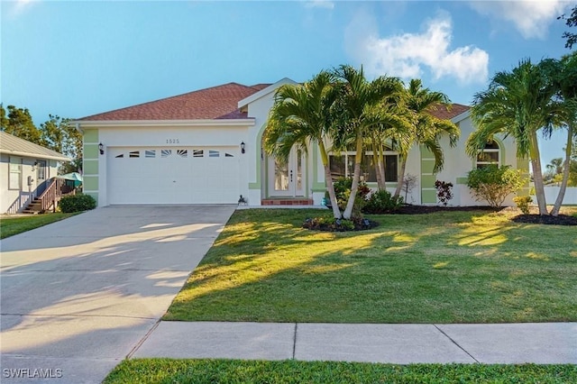 1525 San Marco Rd, Marco Island, FL 34145 - view of front of house featuring stucco siding, an attached garage, driveway, and a front lawn