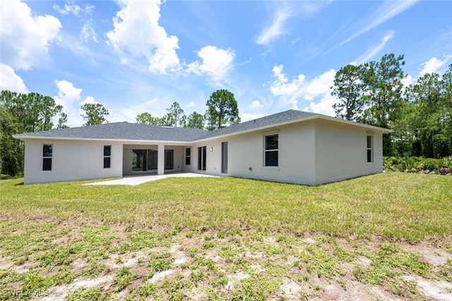 2790 Randall Blvd, Naples, FL 34120 - back of property with a patio area, stucco siding, and a lawn