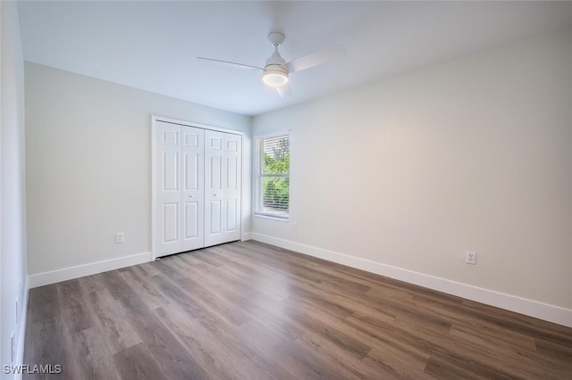 2790 Randall Blvd, Naples, FL 34120 - unfurnished bedroom featuring wood finished floors, a closet, and a ceiling fan