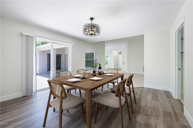 2790 Randall Blvd, Naples, FL 34120 - dining room featuring a chandelier and wood finished floors