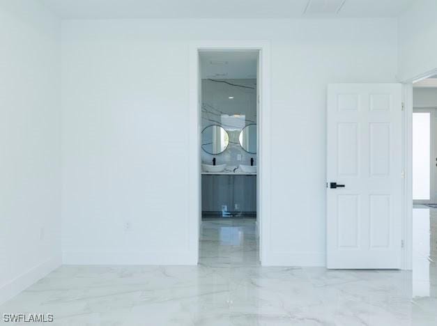 3103 13th St SW, Lehigh Acres, FL 33976 - hallway with light marble finish floors and baseboards