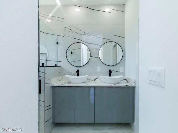 3103 13th St SW, Lehigh Acres, FL 33976 - bathroom featuring double vanity, marble finish floors, and a marble finish shower