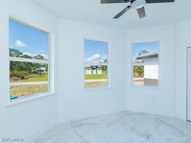 3103 13th St SW, Lehigh Acres, FL 33976 - empty room with marble look tiles and a ceiling fan