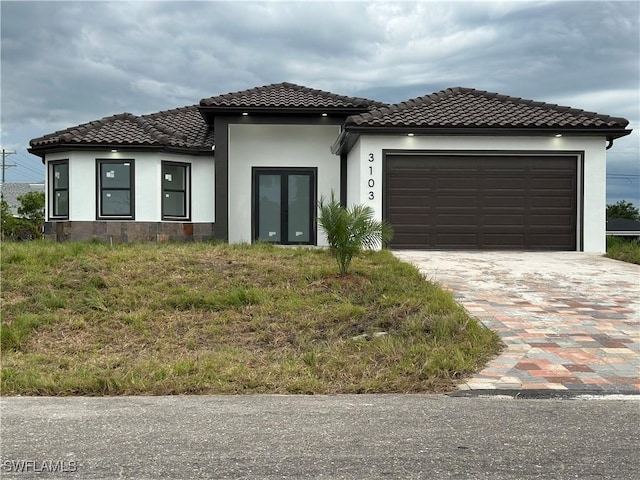 3103 13th St SW, Lehigh Acres, FL 33976 - view of front of home featuring an attached garage, stucco siding, and driveway