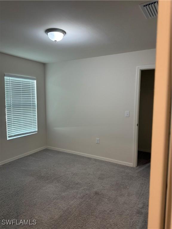 9069 Aegean Cir, Lehigh Acres, FL 33936 - carpeted spare room featuring baseboards