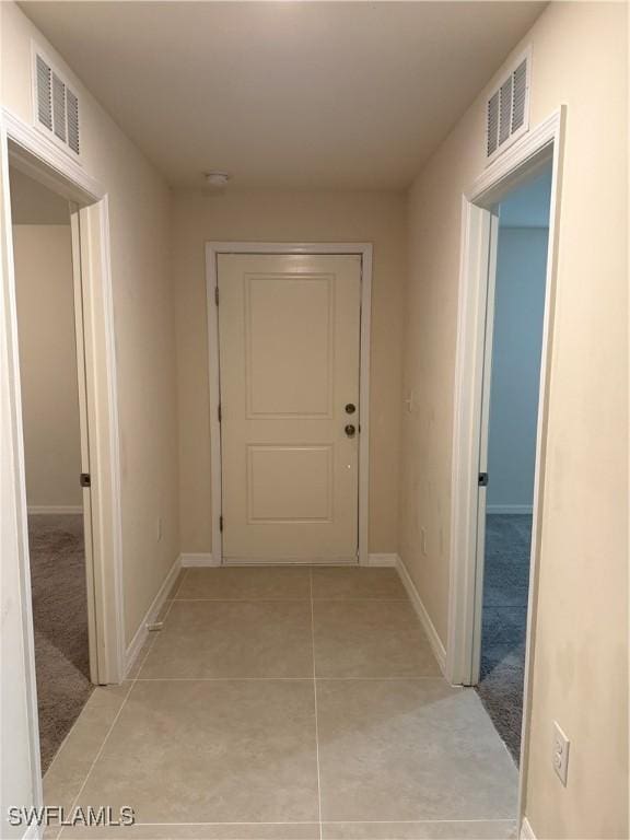 9069 Aegean Cir, Lehigh Acres, FL 33936 - hall with baseboards and light tile patterned flooring