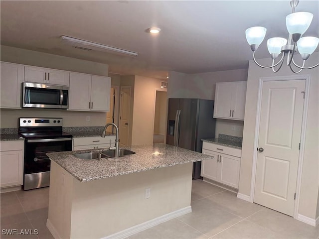 9069 Aegean Cir, Lehigh Acres, FL 33936 - kitchen with appliances with stainless steel finishes, light tile patterned floors, and white cabinetry