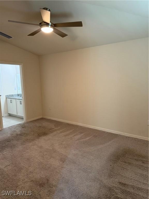 9069 Aegean Cir, Lehigh Acres, FL 33936 - carpeted empty room with ceiling fan and lofted ceiling