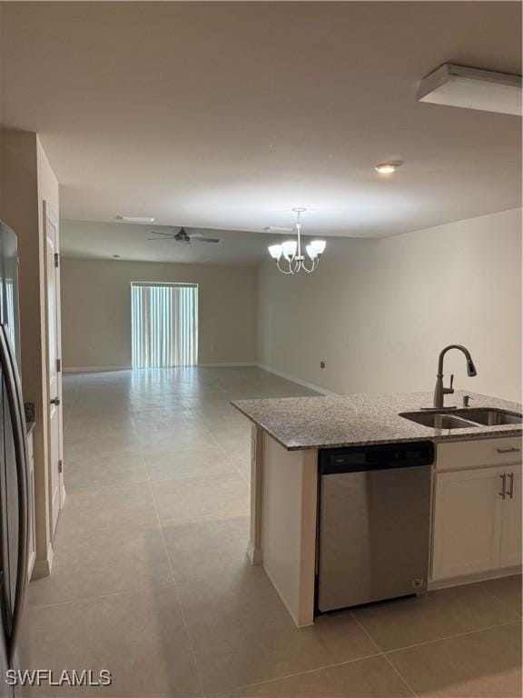 9069 Aegean Cir, Lehigh Acres, FL 33936 - kitchen with stainless steel appliances, light stone counters, white cabinets, open floor plan, and a chandelier